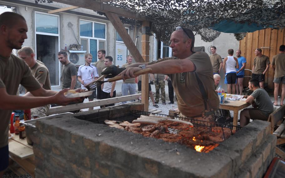 The sergeant major of Germany's 2nd Company, Task Force Kunduz in Afghanistan serves hamburgers and sausages to his soldiers after a two-day patrol. Nicknamed "Spiess," part of a German sergeant major&#39;s traditional job is to be the "Mutter der Kompanie," the mother of the company.