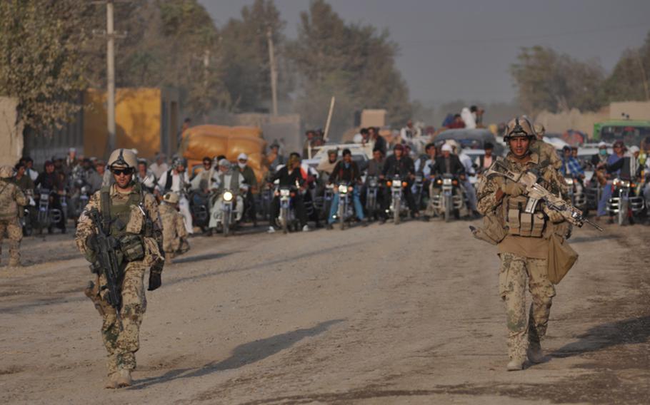 German troops block a road during a search for bombs in Char Dara district, Kunduz province, Afghanistan.