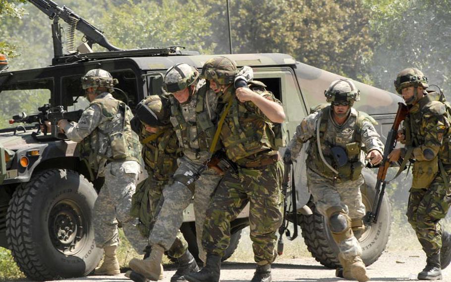 A squad of soldiers attempts to evacuate a "wounded" colleague to safety from the attack area of a convoy ambush training exercise held at the Novo Selo Training Area, Bulgaria in 2006. With the Army poised to begin a substantial troop drawdown in Europe, the Pentagon plans to shift more of its mission in Europe to rotational U.S.-based troops.