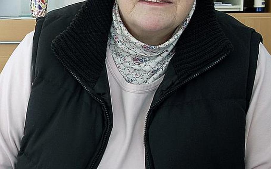 Heidi Conley, 62, sits in her office at Atlantic Trust insurance company in Baumholder, Germany. 'Here, you can fold the sidewalks up if the Americans leave,' she says.
