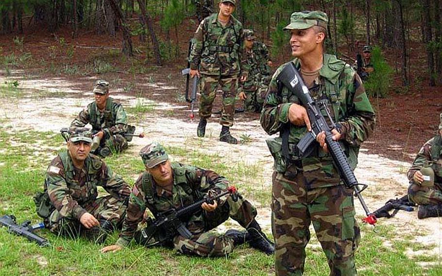 Staff Sgt. Altaie, far left, rests in the grass during basic training at Ft. Hood.