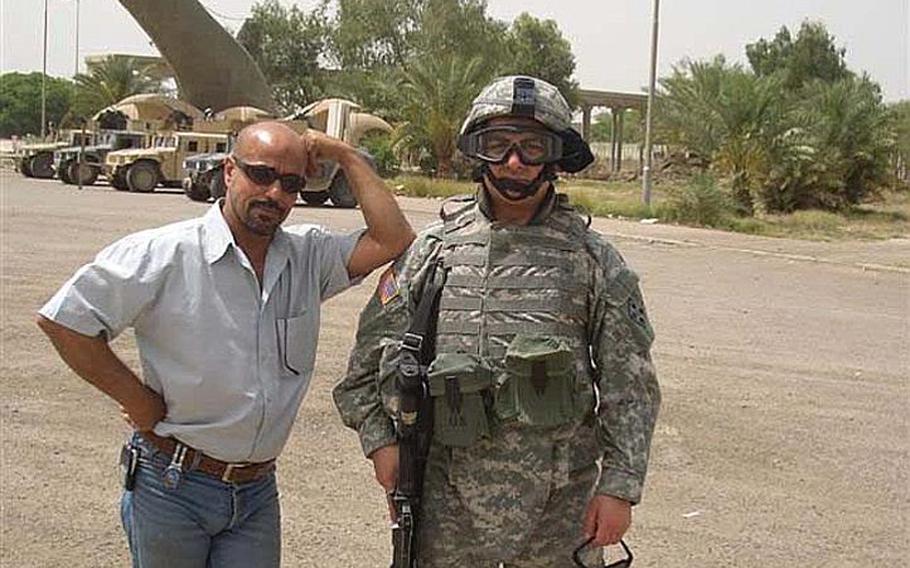 Staff Sgt. Ahmed Altaie, right, poses for a photo with an unknown person at the Swords of Q??disiyyah monument in Baghdad.