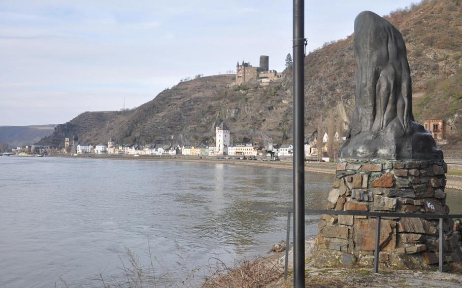 The "Lorelei" statue sits with a beautiful view of the towns of St. Goarshausen, seen here, and St. Goar along with the winding Rhine River.