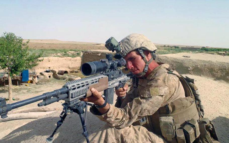 Cpl. Kevin Dubois, a Marine scout sniper, takes aim Helmand Province, Afghanistan, in June 2011, the month before losing his legs in an IED explosion.