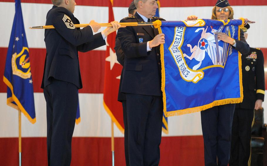 Seventeenth Air Force Command Chief Master Sgt. Michael Grimm, left, holds the guidon as USAFE commander Mark A. Welsh III and Maj. Gen. Margaret H. Woodward,17th Air Force commander, roll up the unit's colors. Seventeenth Air Force was inactivated in a ceremony at Ramstein Air Base, Germany, Friday, three-and-a-half years after being activated at the base.