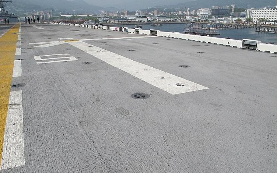 Osprey aircraft could soon be parked on spots like this on the amphibious assault ship USS Bonhomme Richard, which was retrofitted to facilitate their move to the Pacific, seen here at Sasebo Naval Base.
