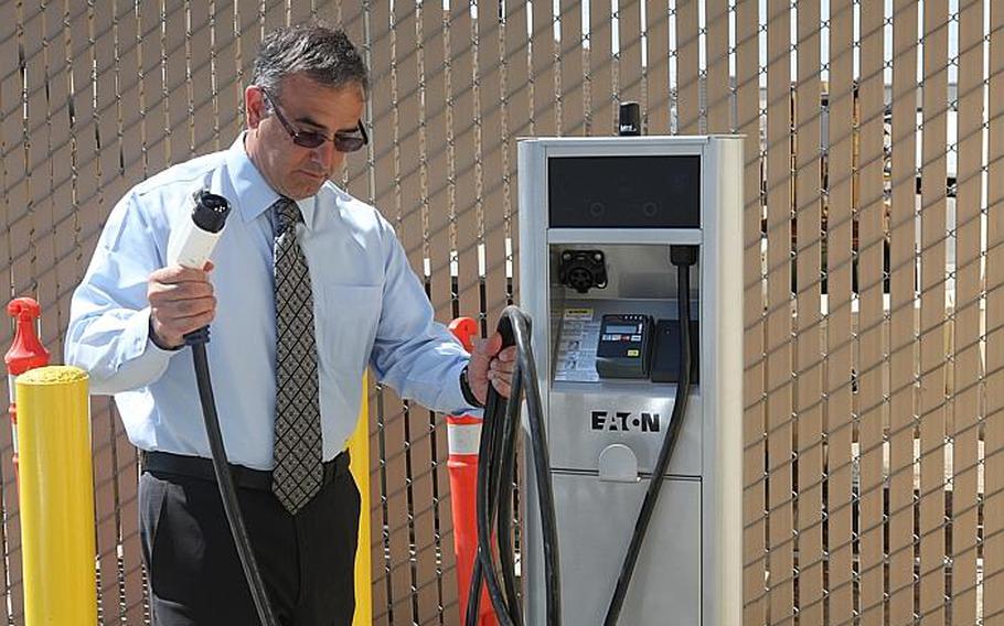 Chris Manis, deputy director of installations and logistics at Marine Corps Air Station Miramar, Calif., prepares to plug a Chevrolet Volt into one of the base's four charging stations for electric vehicles. Miramar received two Volts in July 2012 and plans to field a fleet of electric vehicles.