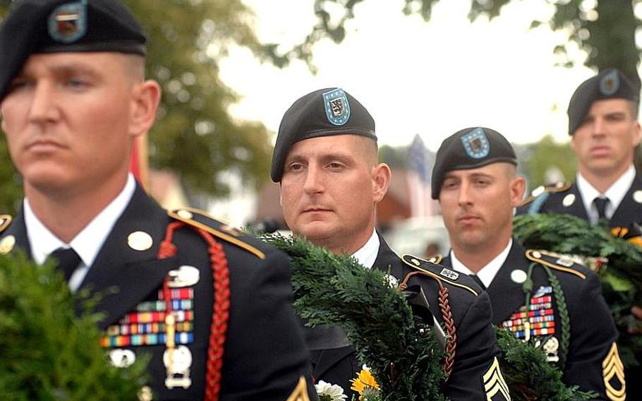 Members of the 172nd Separate Infantry Brigade prepare to place wreaths by the temporary memorials of 10 brigade soldiers who died during the unit&#39;s 11-month deployment to eastern Afghanistan. The recognition was part of a Thursday uncasing ceremony for the brigade in Grafenwöhr, Germany, following the unit&#39;s July return from deployment.