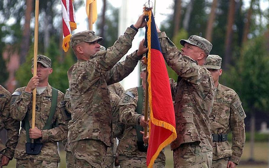 Col. Edward T. Bohnemann, left, and Command Sgt. Maj. Michael W. Boom unfurl the colors of the 172nd Separate Infantry Brigade during a Thursday ceremony in Grafenwöhr, Germany. The brigade returned in July from an 11-month deployment to eastern Afghanistan.