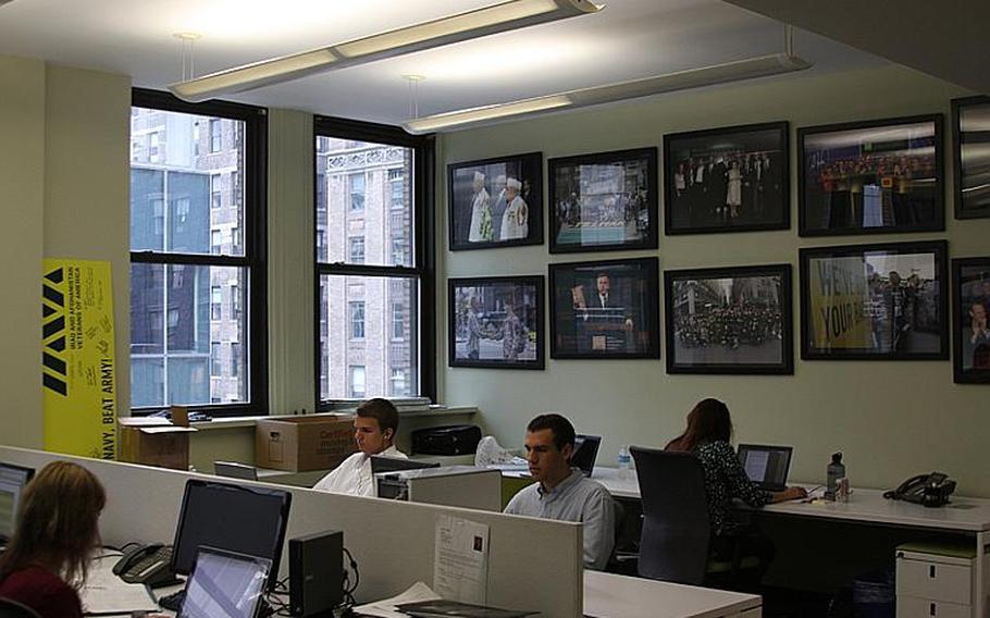Staffers at the Iraq and Afghanistan Veterans of America sit among photos of famous veterans, national politicians and celebrity supporters at the group&#39;s New York office.