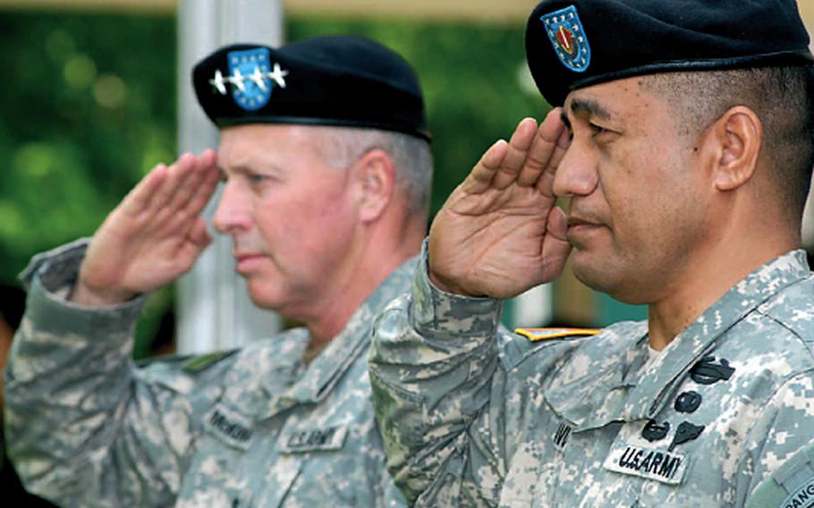In this May 2006 photo, Command Sgt. Maj. Iuniasolua Savusa, the new command sergeant major for U.S. Army, Europe, right, and USAREUR Commander Gen. David D. McKiernan salute during the national anthem at the welcoming ceremony held in Savusa&#39;s honor.