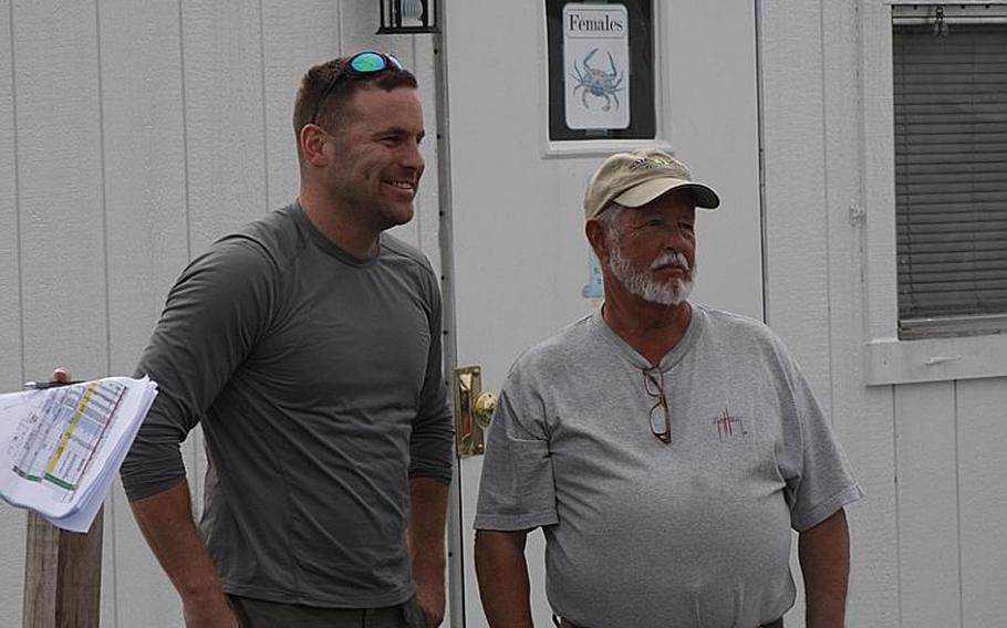 Army Staff Sgt. Robert Bishop, left, poses with his fishing guide, John Rappold, before last month's Stars and Stripers fishing tournament with Project Healing Waters. Bishop is a regular at the group&#39;s outings and credits the therapeutic value of fly fishing with helping him address symptoms of post-traumatic stress disorder.