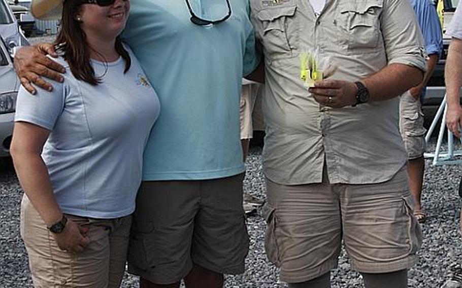 Chris Frost, an Air Force veteran, and his wife, Cathy, an Army veteran, pose with their captain for the day, Richie Gaines, center, after Project Healing Waters&#39; Stars and Stripers tournament last month in Chester, Md. Gaines was one of more than a dozen local fishermen and charter captains who volunteered their boats for the event.