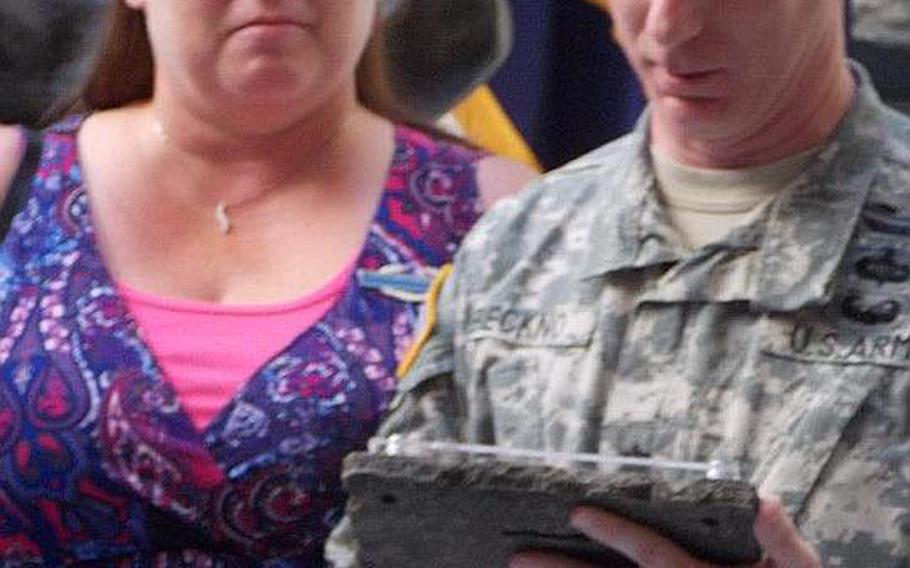 Lauri Turner listens as Lt. Col. Brian Beckno, commander of the 2nd Battalion, 87th Infantry Regiment, reads a plaque commemorating her son&#39;s combat service in Afghanistan. Turner&#39;s son, Spc. Jacob Andrews, earned the combat infantryman badge but did not receive it. He later was forced out of the Army and hanged himself in the woods near his childhood home.