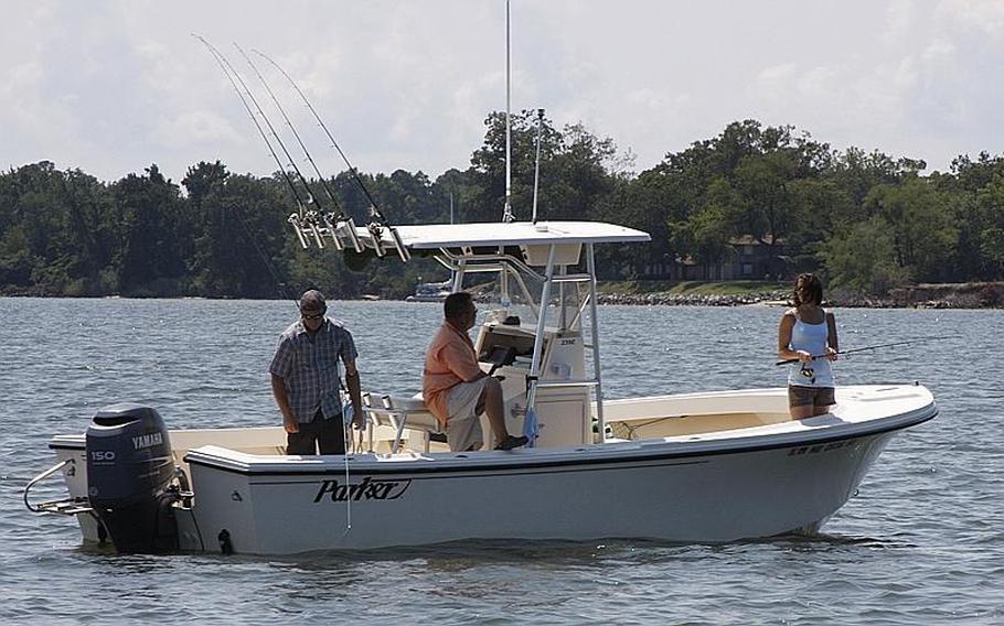 Marine Corps veteran Sean Locker, left, fishes during Project Healing Waters' Stars and Stripers tournament last month in Chester, Md.