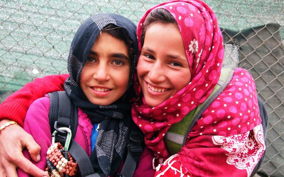 Kushi, right, 14, sold scarves on the street outside NATO headquarters in Kabul, but was also a mentor and skateboard instructor at Skateistan, a non-governmental organization based in Kabul. Here she is seen with Farzana another street seller.