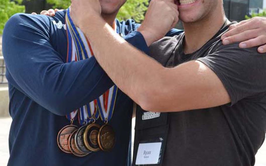 Redmond Ramos, left, hams it up with his brother, Ryan, at the completion of this year's Warrior Games in Colorado Springs, Colo. Redmond Ramos, who lost his lower left leg during a bomb blast in Afghanistan, won five medals at the games.