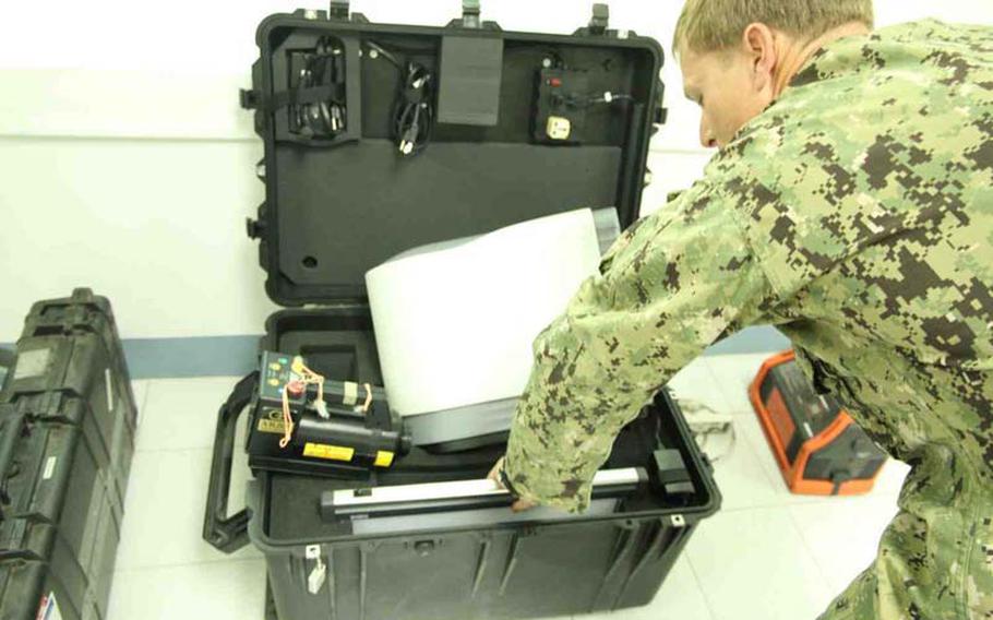 Navy EOD expert Lt. Casey McHenry shows the newest technology for X-raying packages for concealed bombs during a recent IED training session near General Santos City, Philippines. The U.S. has provided equipment and expert assistance to the country as part of Operation Enduring Freedom-Philippines.