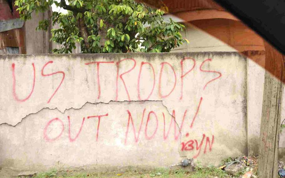 Graffiti near the front gate of Camp Navarro in Zamboanga urges U.S. troops to leave the area. Members of the U.S. task force at the camp keep a low public profile while advising the Armed Forces of the Philippines in its battle against transnational terrorist groups.