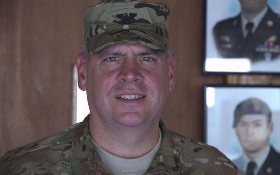 Col. Mark A. Miller, commander of Joint Special Operations Task Force-Philippines, stands in front of a memorial in Camp Navarro for two Special Forces soldiers killed by a roadside bomb in 2009.