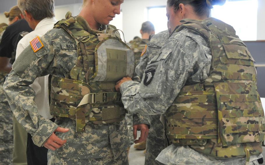Spc. Arielle Mailloux gets some help adjusting her protoype Generation III Improved Outer Tactical Vest from Capt. Lindsey Pawlowski, Aug. 21, 2012. Both Soldiers are with the 1st Brigade Combat Team Female Engagement Team, 101st Airborne Division (Air Assault). These prototypes designed specifically for the needs of female soldiers, with shorter torso length and other improvements, are being fielded at Fort Campbell, Ky., for the next few weeks.