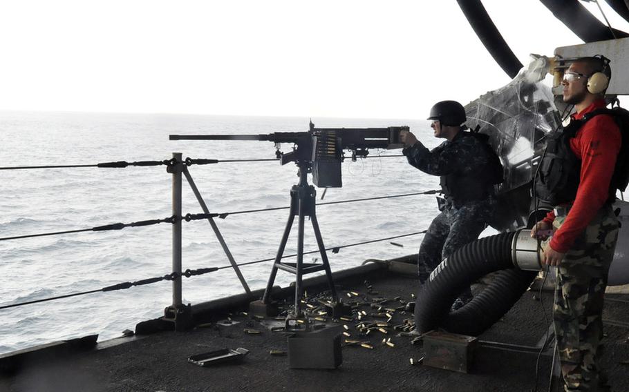 Brett Ruopp, a 21-year-old gunners mate third class, fires his machine gun during an exercise aboard the USS Enterprise. Ruopp said he is more worried about why his girlfriend stopped sending him emails than a potential new conflict in the Middle East.