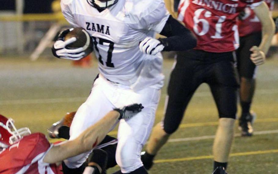 Zama American running back Mitchell Harrison knifes his way through Nile C. Kinnick defenders during Friday's DODDS Japan-Kanto Plain Association of Secondary Schools football game at Yokosuka Naval Base, Japan. Harrison scored a touchdown in his first game back after shoulder surgery, and the Trojans rallied to beat the Red Devils 14-13.