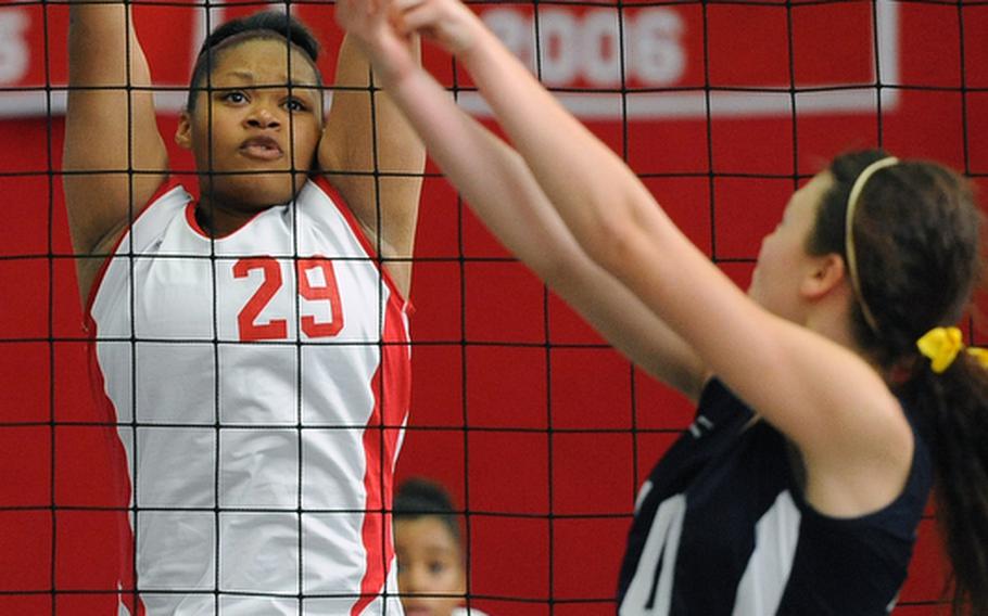 Kaiserslautern's Kalynn Richardson, left, goes high to try to block a shot by Bitburg's Michelle Morrison in their match in Kaiserslautern, Saturday. Kaiserslautern won 25-13, 25-18, 25-23.