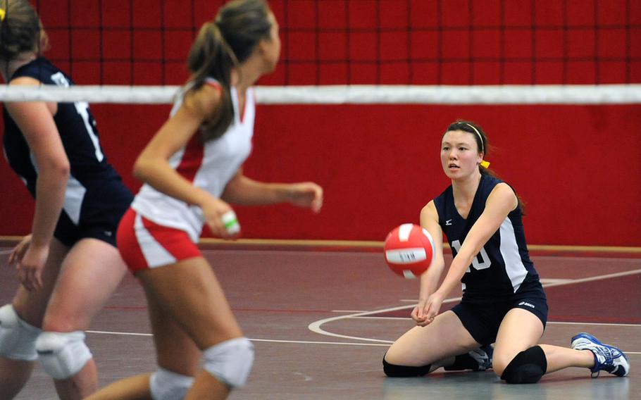 Bitburg's Michelle Morrison goes to her knees to dig out a Kaiserslautern serve in a match in Kaiserslautern, Saturday. The home team won 25-13, 25-18, 25-23.