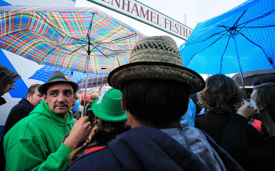Revelers wait in the rain outside Oktoberfest&#39;s Schottenhamel tent - where the festivities begin - before being told the tent was already full. By then, many had waited nearly two hours in the rain.