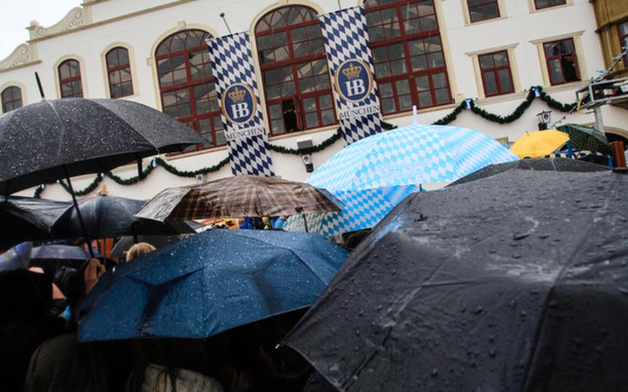 While revelers party inside, thousands more wait in the rain to get into Oktoberfest&#39;s 14 tents.