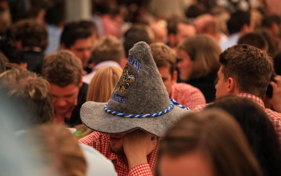 As rain dampened the mood outside Saturday, partygoers inside waited hours for Oktoberfest to begin, though with the comfort of warmth, pretzels and bottled beer.