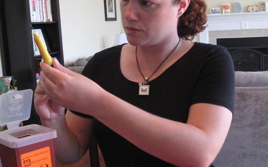 Sallie Bailey pushes the air out of her Follistim pen, a syringe containing fertility drugs, before giving herself an injection as part of an in vitro fertilization cycle. Bailey and her husband, Marc, an Army major, have worked with numerous doctors over the last three years in an attempt to have a child, but so far have had no success.
