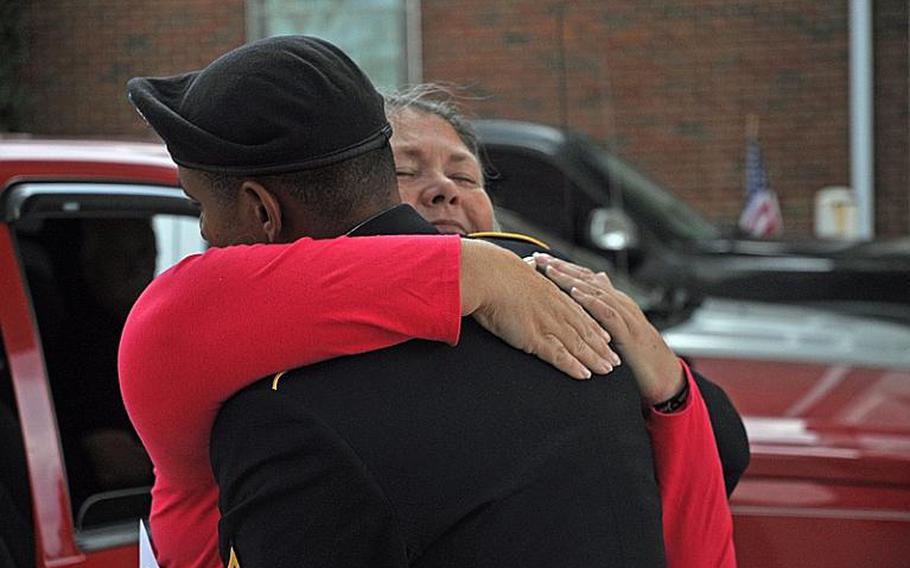 Karen Nelson hugs a member of the Honor Guard who attended her son&#39;s funeral Sept. 28 in Claremore, OK. Pfc. Jon Townsend, 19, was killed in an insider attack on Sept. 16 in Afghanistan.