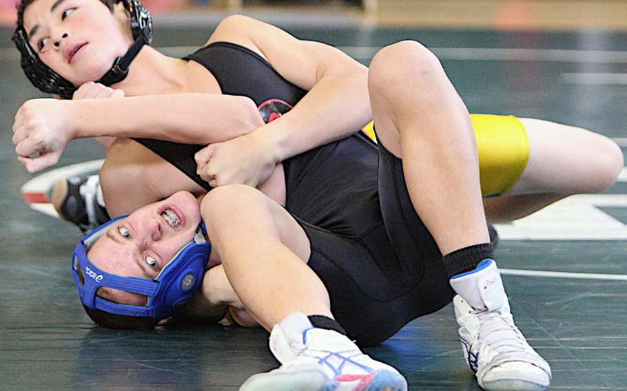 Nile C. Kinnick's Brady Yoder gets the upper hand on Bryce Potts of Yokota during a 122-pound bout in Saturday's Robert D. Edgren Invitational Wrestling Tournament at Misawa Air Base, Japan. Yoder won the weight-class gold medal and Kinnick won the team title.