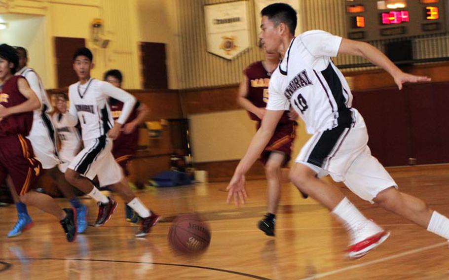 Matthew C. Perry's Jon Cadavos dribbles upcourt against the Marist Brothers International School Bulldogs during Saturday's high school boys basketball game at Marine Corps Air Station Iwakuni, Japan. The Samurai won 53-21.