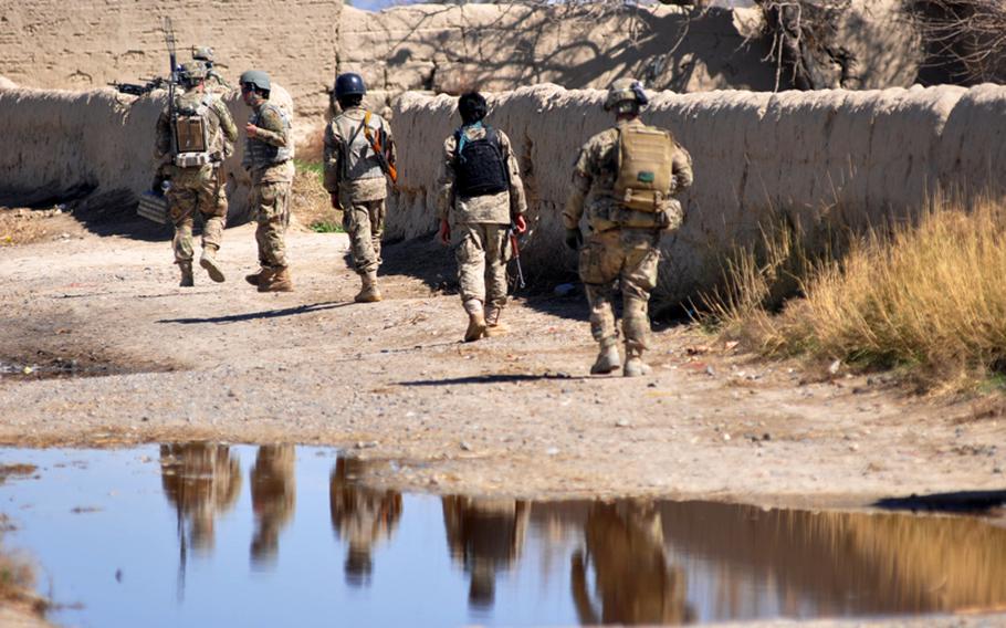 Afghan National Security Forces and members of 4th Battalion, 9th Infantry Regiment leave a village near Forward Operating Base Zangabad after a patrol to search houses, question residents and hand out leaflets.
