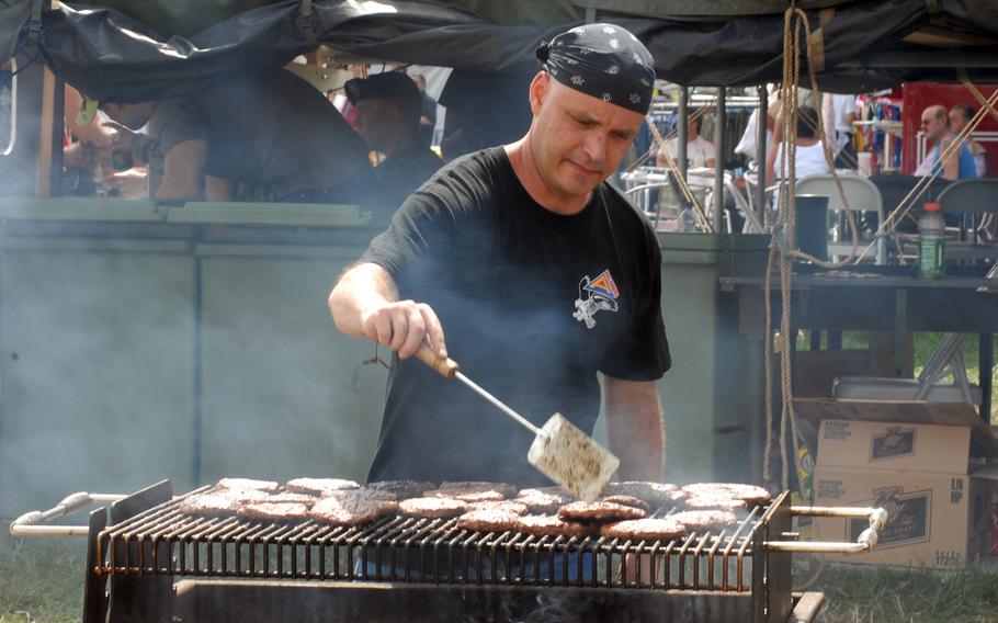 Norvell West fries burgers at the Headquarters Headquarters Company, Joint Multinational Training Command booth at Grafenwohr's German-American Volksfest in August 2008.