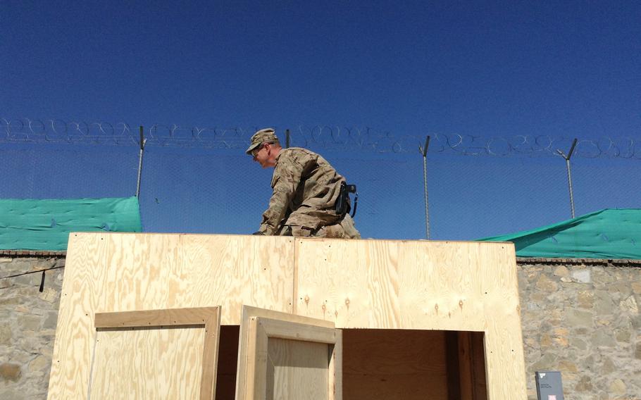 Sgt. Brian Paquette puts the finishing touches on a new waterless latrine at Forward Operating Base Rushmore. The latrine will get minimal use for now, but officers say it's only a matter of time before it will be needed as sanitation contracts end with the drawdown of U.S. forces from Afghanistan.