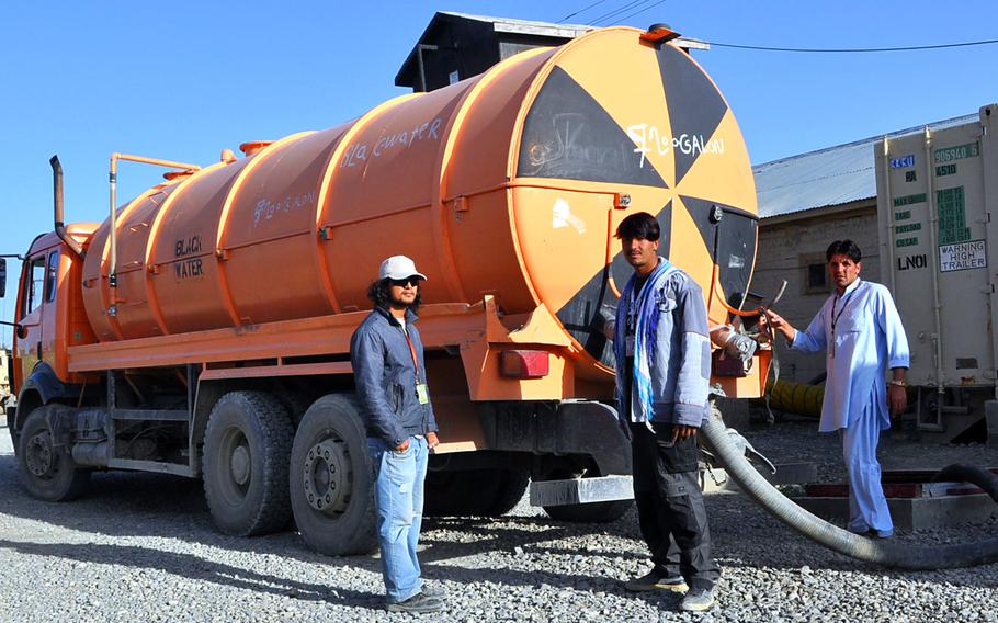Afghan contractors collect wastewater on Forward Operating Base Rushmore on the last day of their Fluor Corp. contract. The same people will likely be back under a direct Army contract.