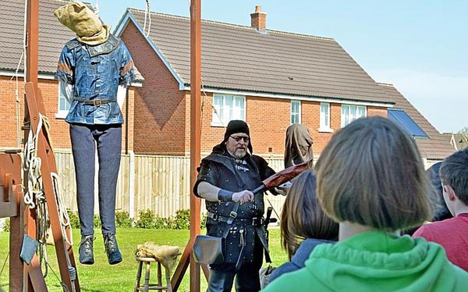 ''Executioner'' John White tells Lakenheath Middle School students about criminal punishments in the Middle Ages during UK Day on Friday at RAF Feltwell. The day is a chance for students to learn from experts on English history and culture.