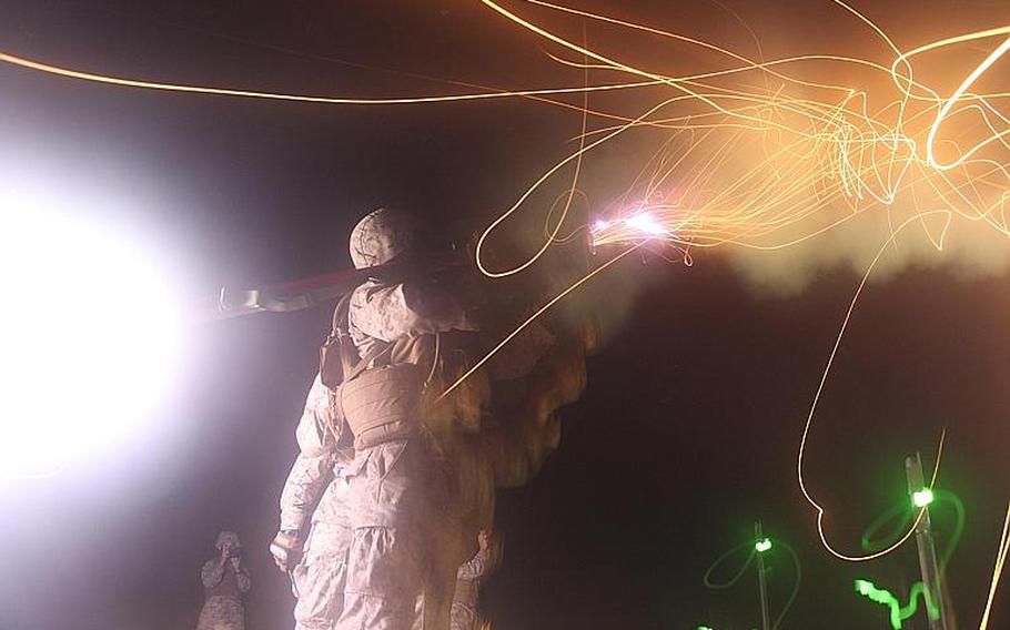 Flames light up the sky, after a Marine launches a PL-87 Stinger Missile at a flying drone at Onslow Beach on Marine Corps Base Camp Lejeune during the night fire portion of the 2nd Low Altitude Air Defense Battalion's live stinger fire exercise.