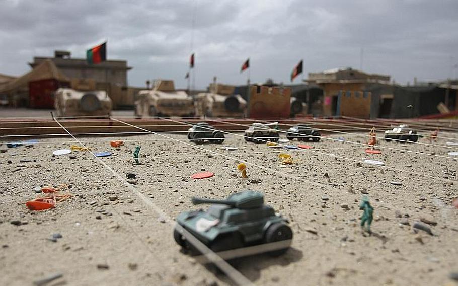 Afgan National Army Capt. Kamal, the Route Clearance Tolai commander for 2nd Brigade, 215th Corps, uses this sandtable kit to plan his tolai's missions on Forward Operating Base Nolay, Sangin District, Helmand province, Afghanistan.