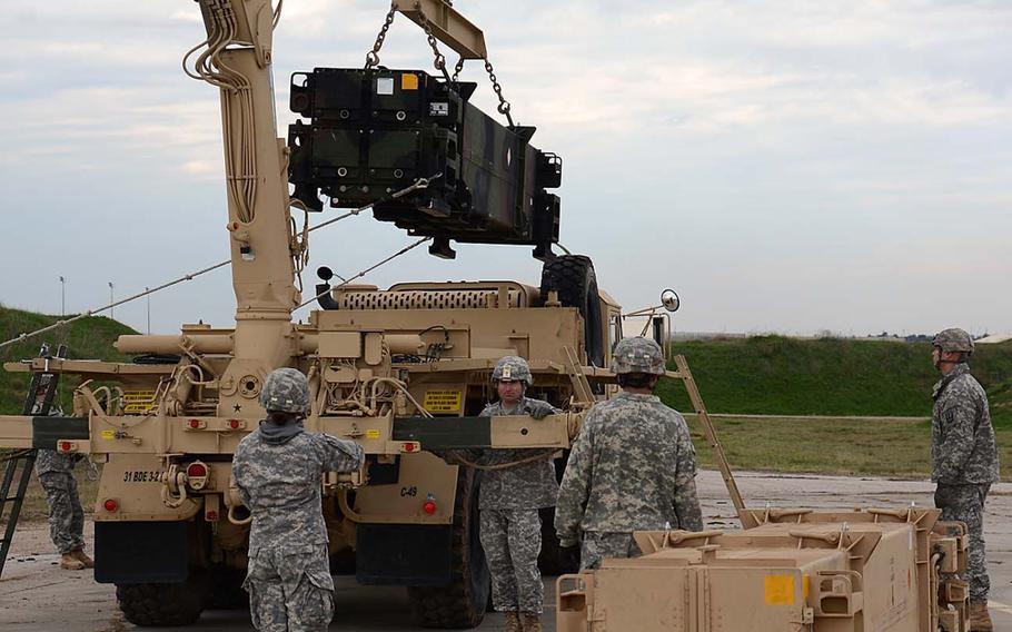 Soldiers with the 3rd Battalion, 2nd Air Defense Artillery load Patriot missiles onto their launchers at Incirlik Air Base, Turkey, in January. NATO deployed six Patriot anti-missile batteries to Turkey's border with Syria as part of an effort to shield its ally from potential strikes from Syria.