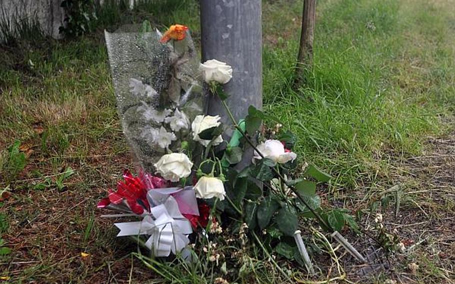 Flowers left along the mountain highway where an Italian teen was killed when his vehicle was struck by a car driven by a U.S. Airman stationed at Aviano, Italy, according to local police.