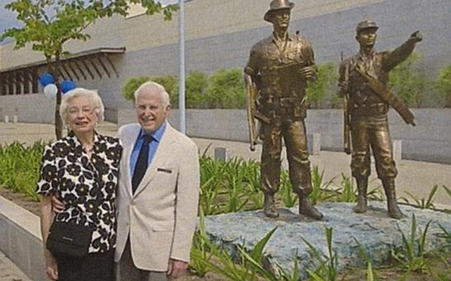Sam Spector and his wife Virginia pose beside the Kachin Rangers statue on the day of its dedication at the U.S. Embassy in Yangon.