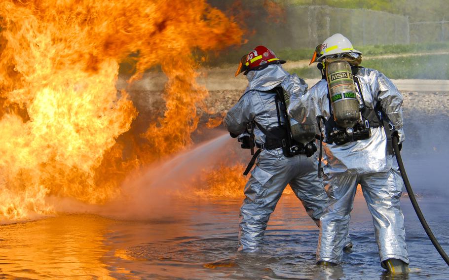 U.S. Air Force firefighters from the 182nd Civil Engineer Squadron combat a kerosene-based fuel fire at the 182nd Airlift Wing in Peoria, Ill., on May 13, 2013. The firefighters tested the capabilities of their P-34 Rapid Intervention Vehicle during a controlled-burn exercise using ultra-high pressure water dispersal technology.