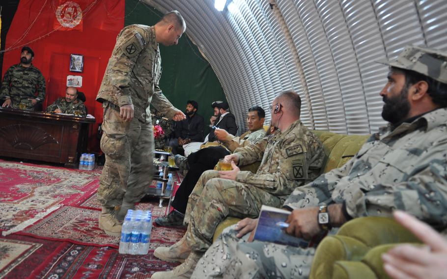 Afghan and American officials, including Maj. Gen. Clarence Chinn, seated third from right, deputy commander of Regional Command East, meet at a security Shura in Paktika province in April as part of negotiations over the future of Forward Operating Base Sharana.