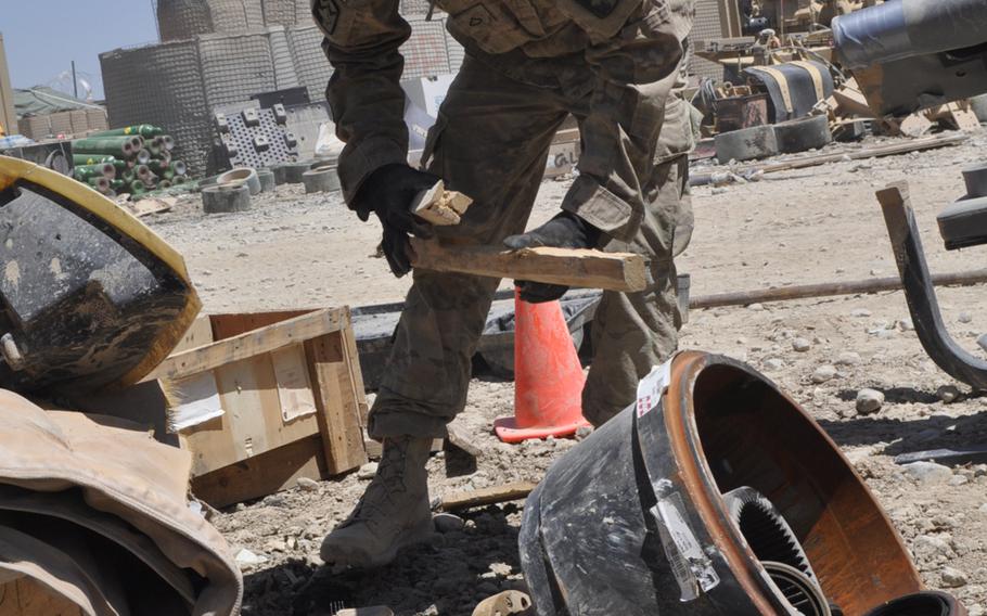 Pfc. Justin Converse of the 289th Quartermaster Company works in the retrograde yard at Forward Operating Base Sharana, sorting equipment and materiel that can be sent back to the U.S., given or sold to Afghans or disposed of. Even as American and Afghan officials try to make arrangements to transfer the base to Afghan forces, Americans are facing a deadline to turn the FOB back into dirt by October.