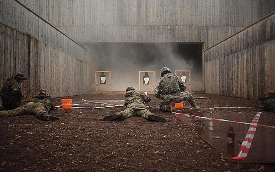 Competitors take aim at paper targets with American M-249 squad automatic weapons at the Monte Kali shooting competition Friday in Wackernheim, Germany.